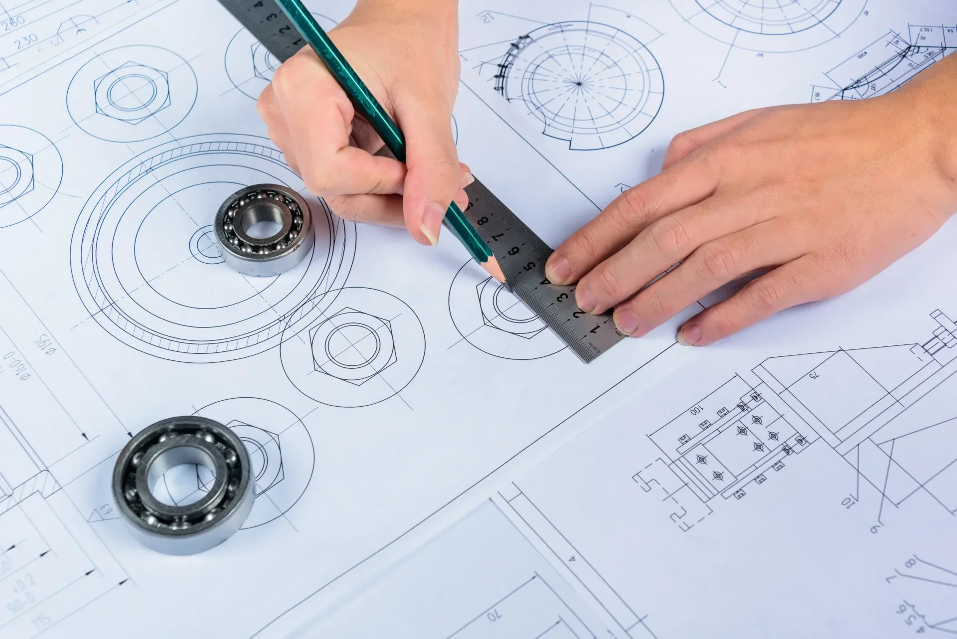 Teknik proje çizimi Teknik çizim üzerinde cetvel ve kalemle çalışan kişi